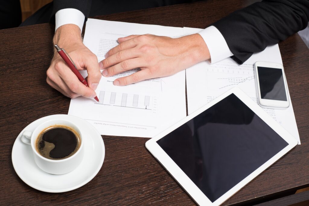 Businessman using digital tablet with charts for planning and analysis of business models, startup.